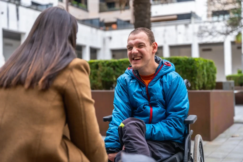 Disabled man in wheelchair with support worker