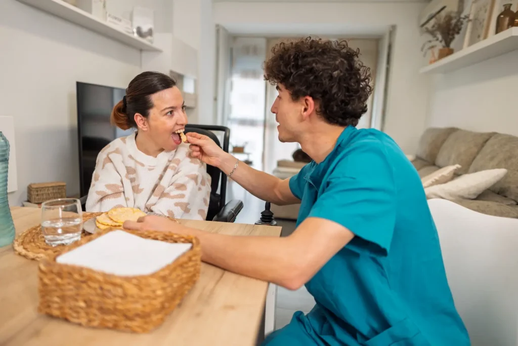 Nurse helping disabled woman eat